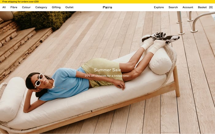 Pairs Socks hero: poolside lounger photo with centered Summer Sale and 20% off overlay