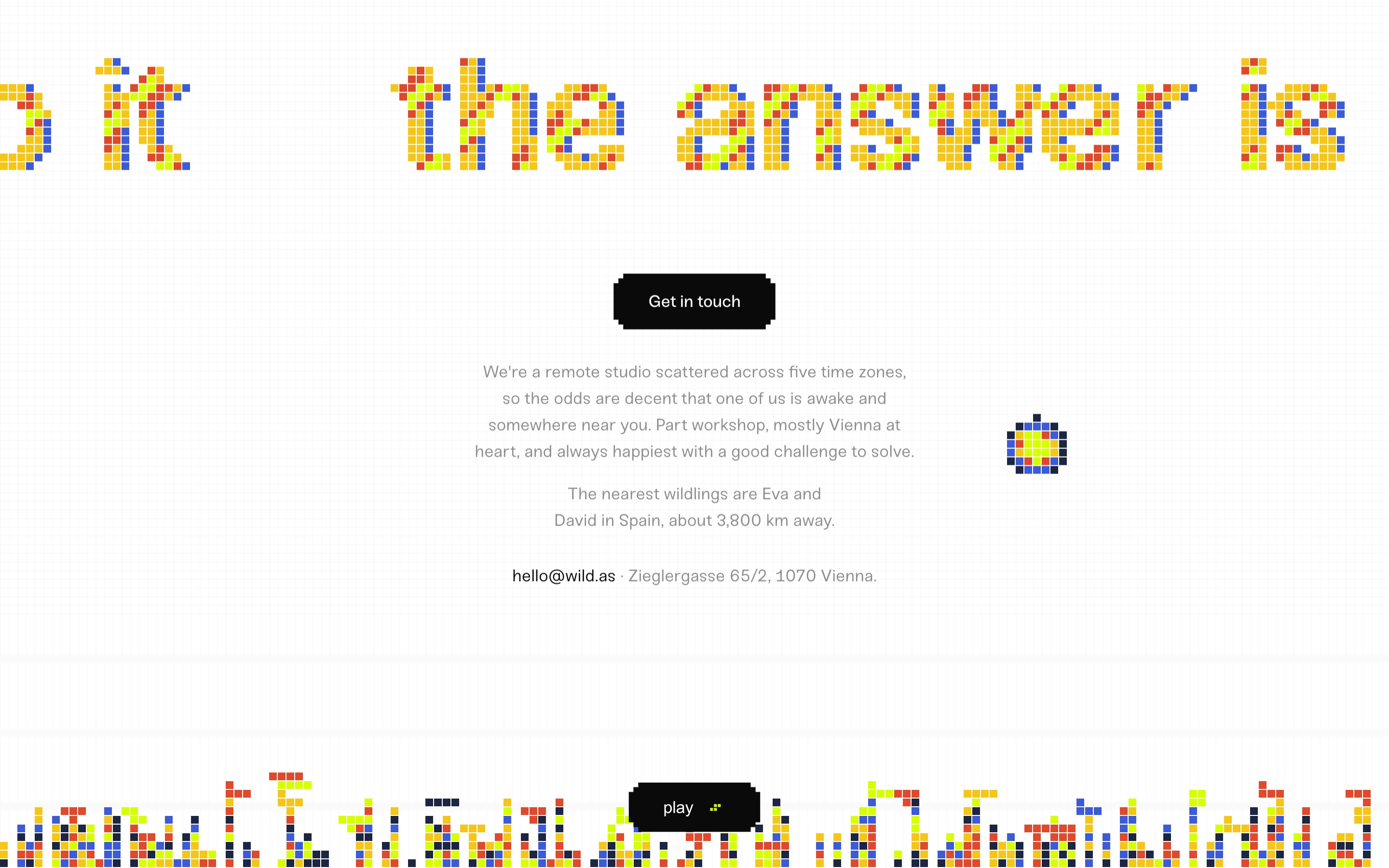 Wild footer with colorful pixel headline ‘the answer is’, Get in touch button, studio copy, Vienna address, play bar