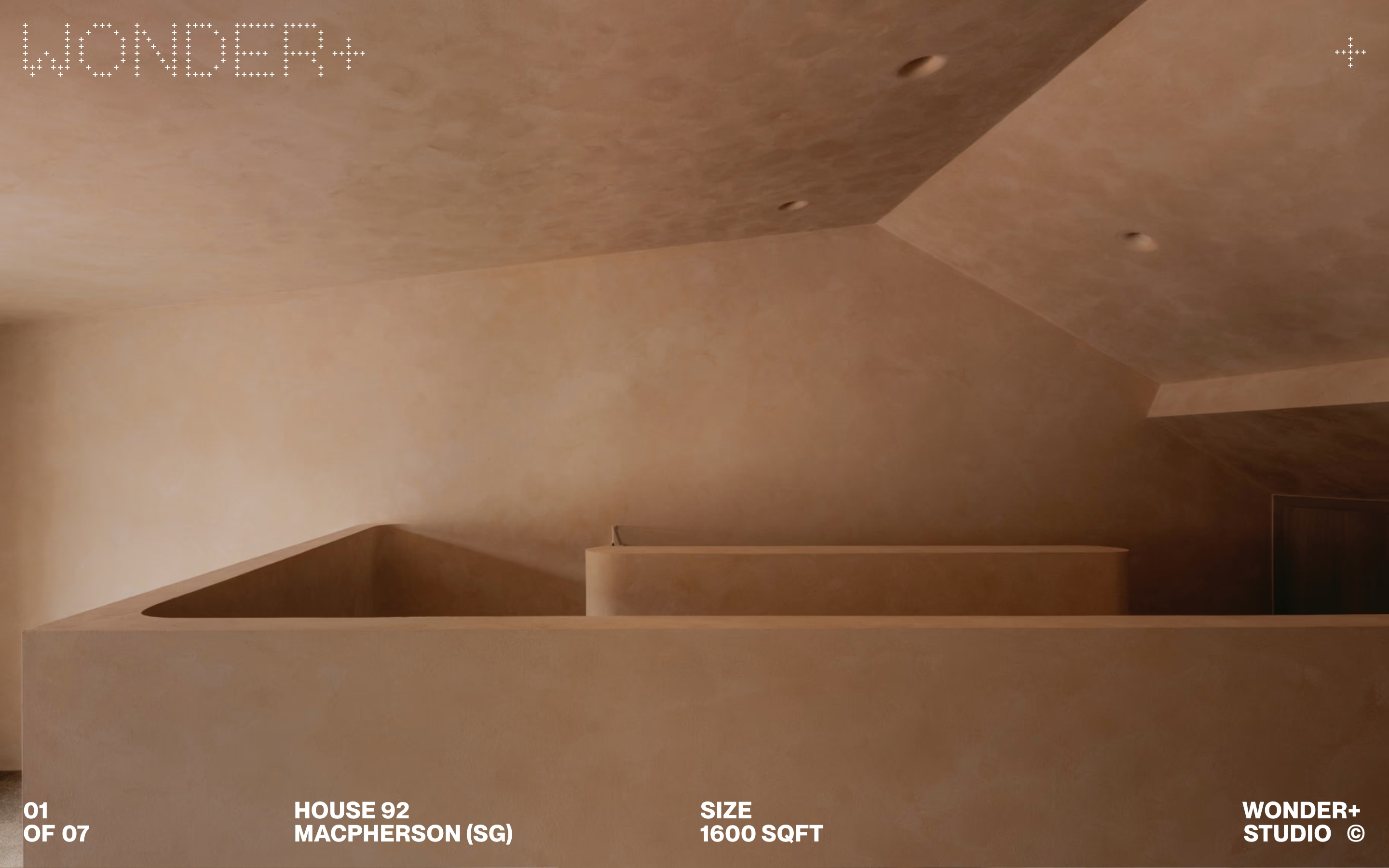 Wonder Plus Studio hero: terracotta House 92 interior with WONDER+ mark and bottom project captions