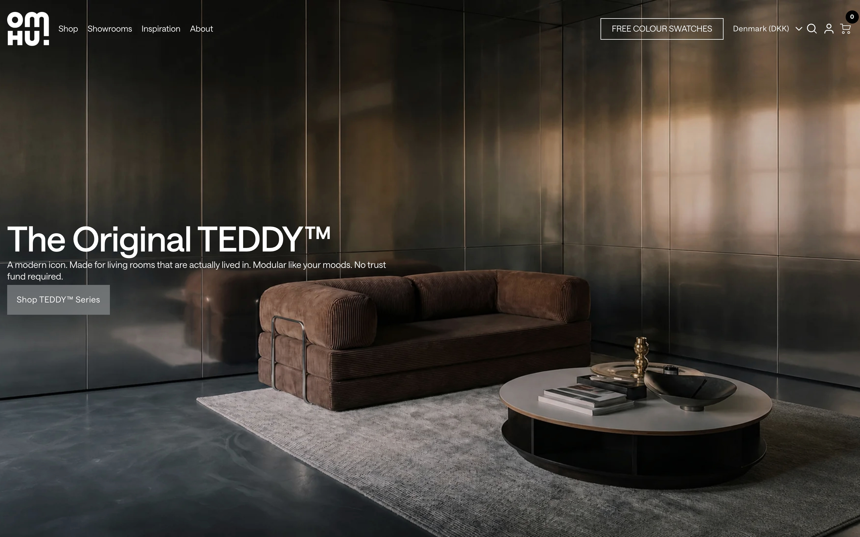 Omhu hero: dark metallic living room with brown TEDDY sofa, left overlay headline, and Shop TEDDY Series button